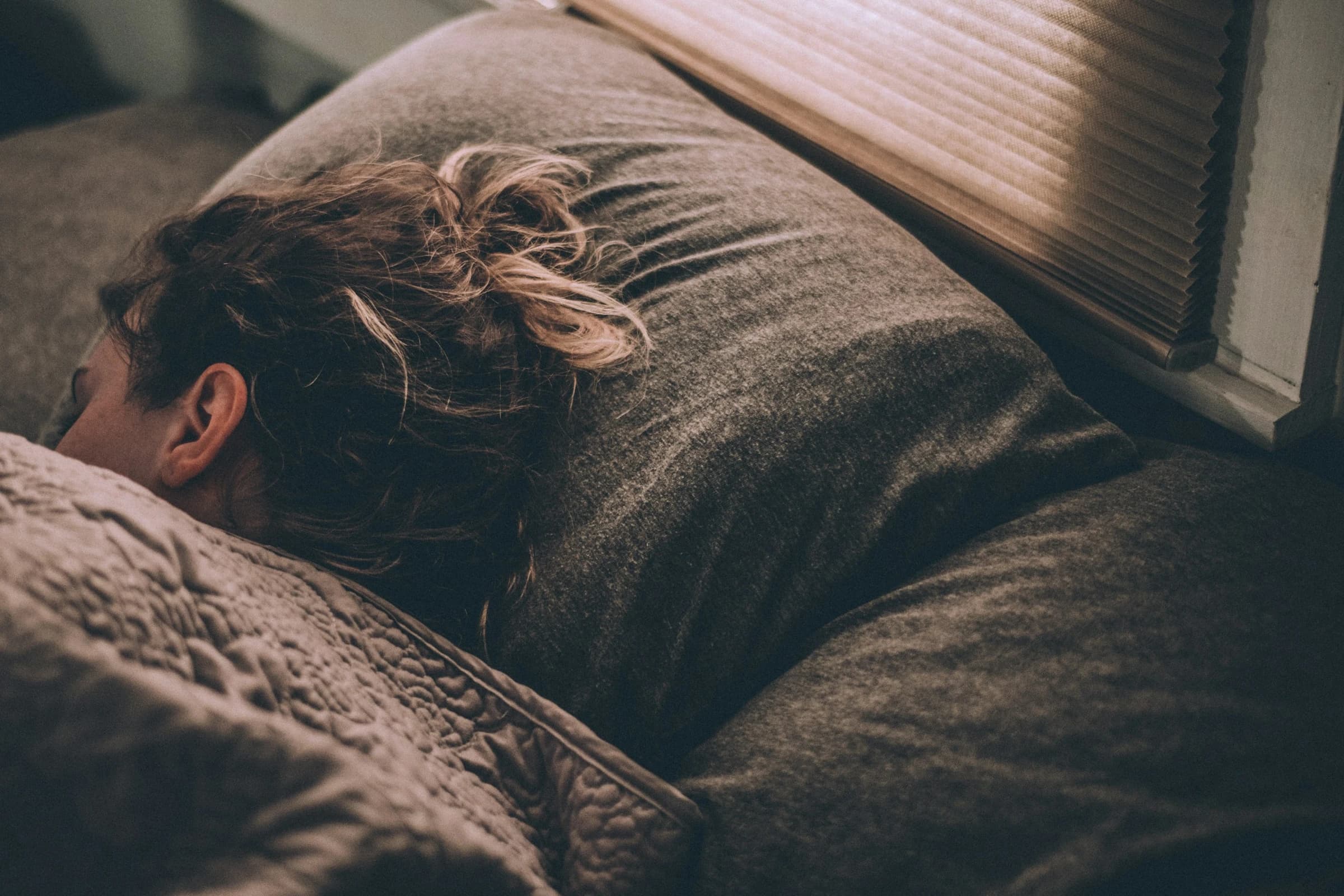 Calm bedroom scene at dusk — visual cue for the sleep schedule recommendation card